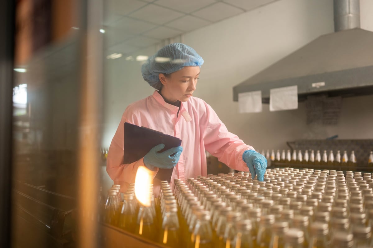 Worker inspecting bottled beverage